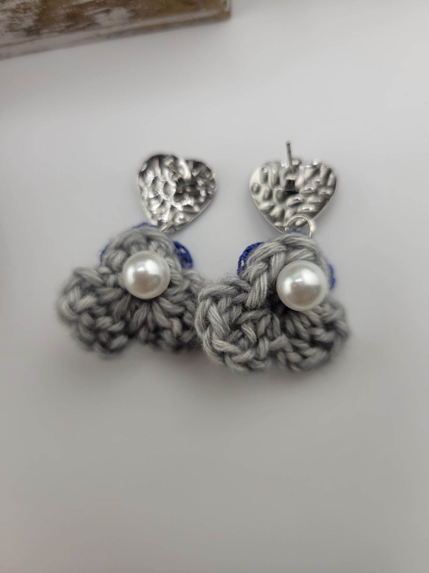 Handmade Bohemian-style Crochet Flower Earrings with a mixed colored stone center, attached to hammered Stainless steel metal earring top