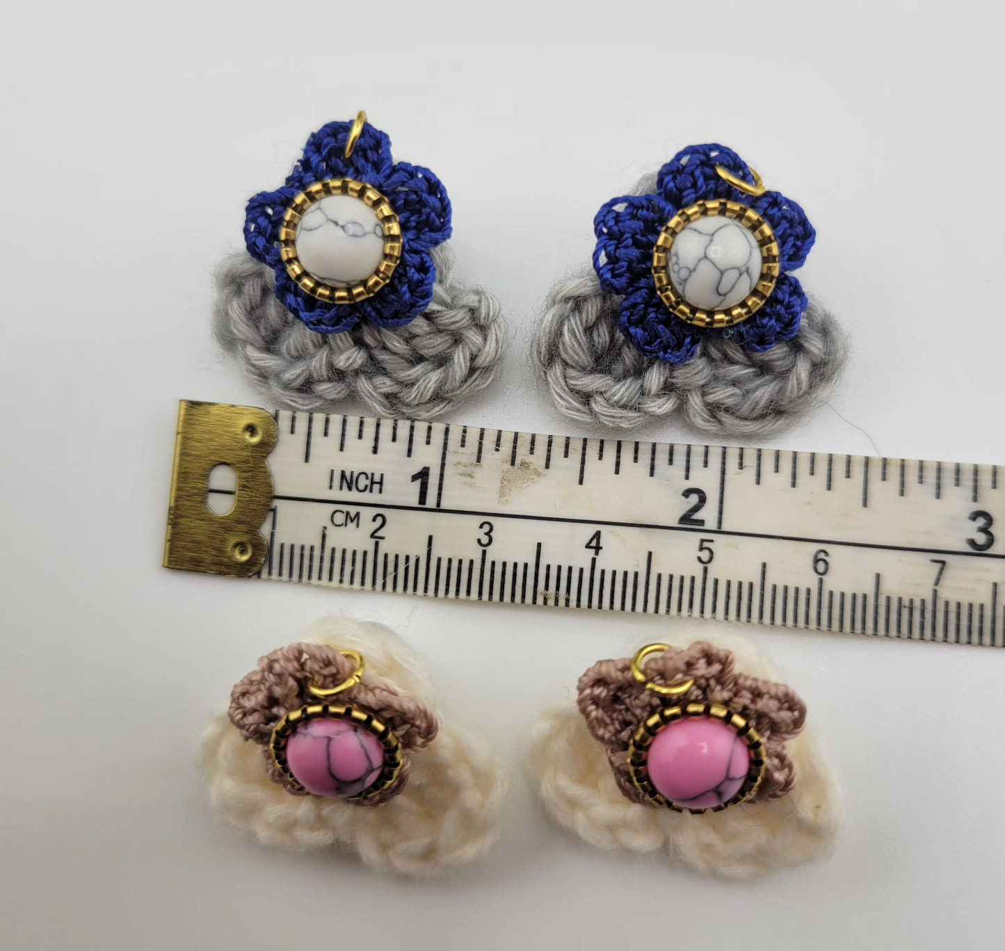 Handmade Bohemian-style Crochet Flower Earrings with a mixed colored stone center, attached to hammered Stainless steel metal earring top