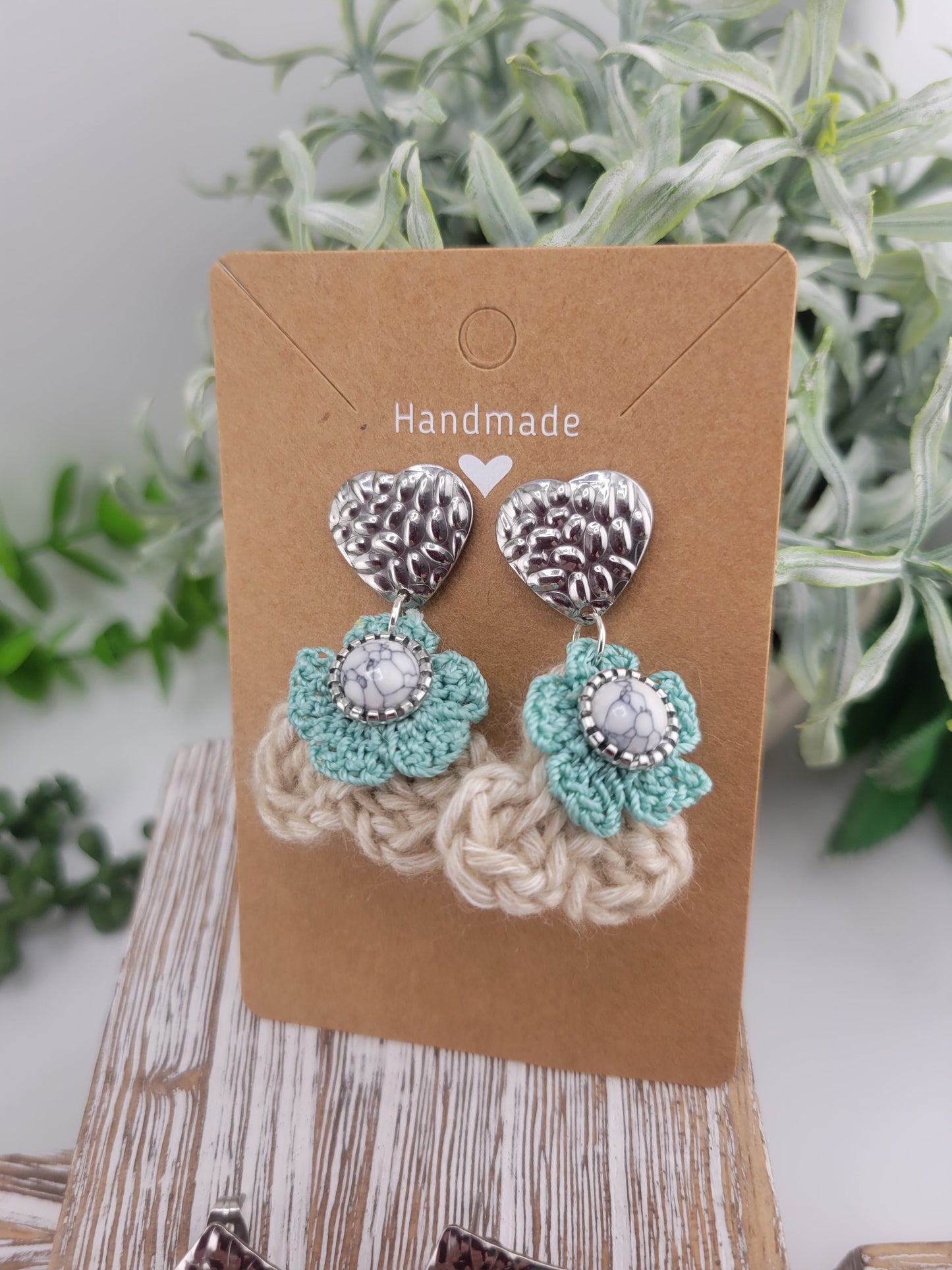 Handmade Bohemian-style Crochet Flower Earrings with a mixed colored stone center, attached to hammered Stainless steel metal earring top